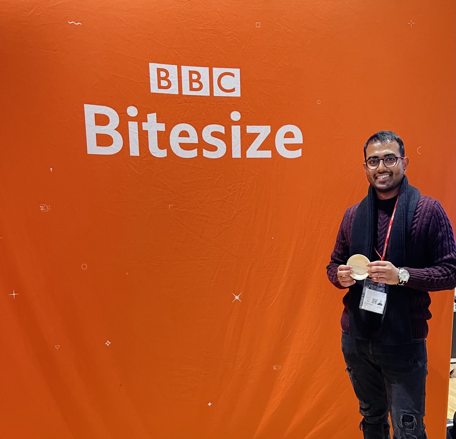 Palm Life founder holding palm leaf tableware in front of a BBC Bitesize backdrop